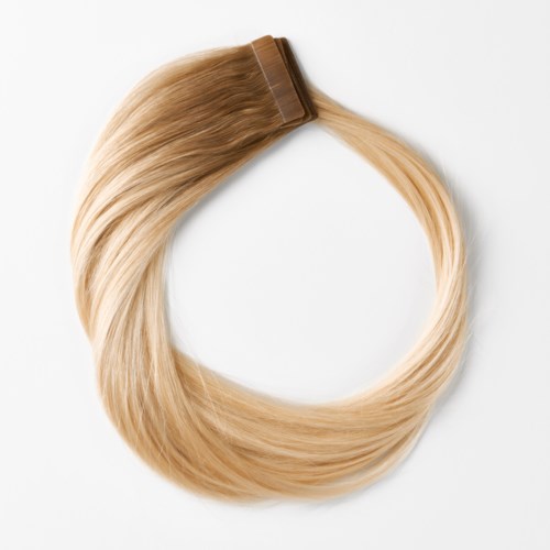 Lyseblonde hårforlængelse med clip, formet som en cirkel på hvid baggrund.