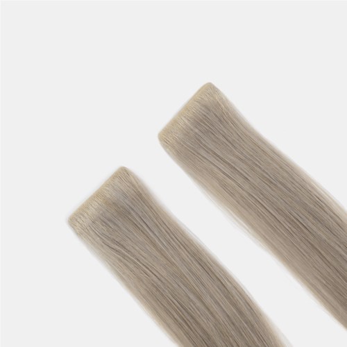 Two blonde hair extensions or wigs placed diagonally on a white background.