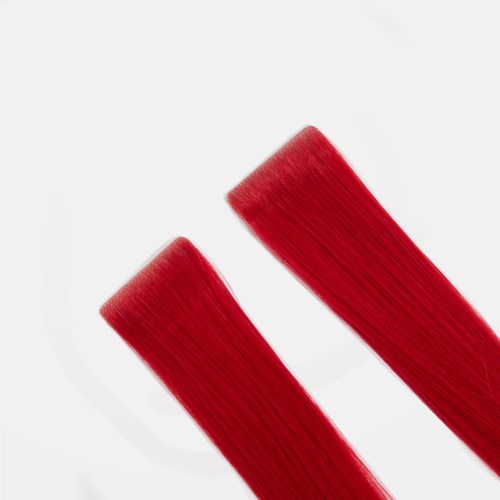 Two red hair extensions lying parallel on a white background.