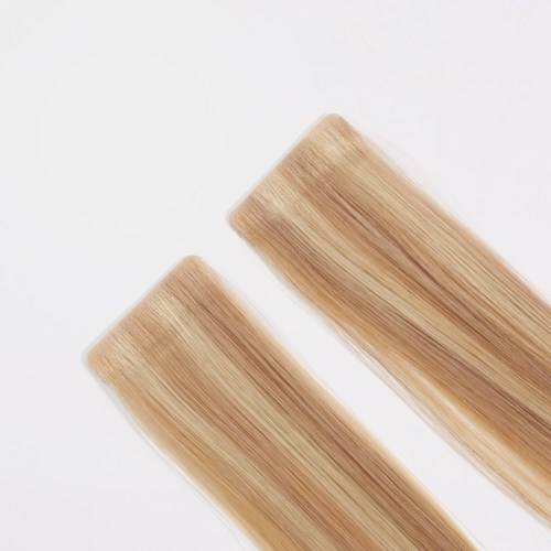 Two strips of blonde hair extensions on a white background.