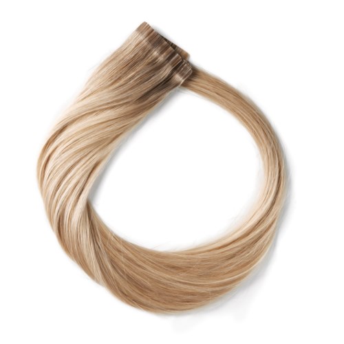 En tofs av blond hår formad som en cirkel med en slät, glänsande textur.