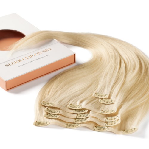 A set of wig clips and a blonde wig on a white background.