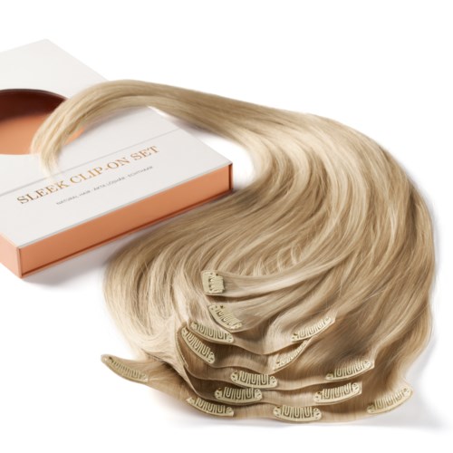 Blonde hair extensions with clips inside a box labeled "Sleek Clip On Set."