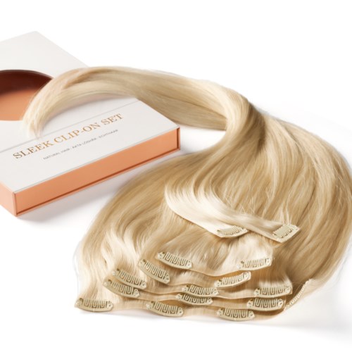 A blonde hair extension set with clips, next to a pink and white box labeled "Sleek Clip On Set."