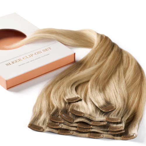 A set of hair extensions with clips, light blonde color, placed near a box labeled 'SLEEK CLIP ON SET.'