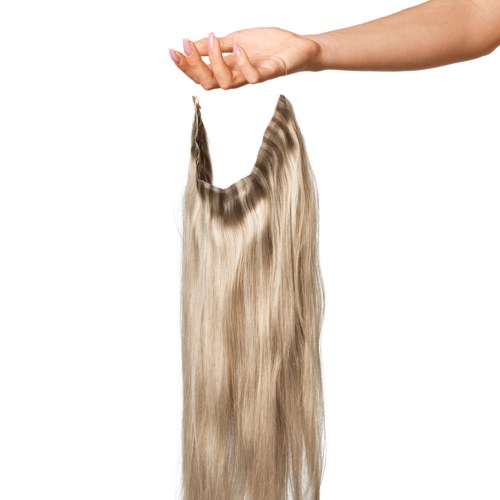 A hand holds a lock of long, straight, blonde hair against a white background.