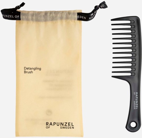 A brush, a black wide-tooth comb, and a beige drawstring bag with text.