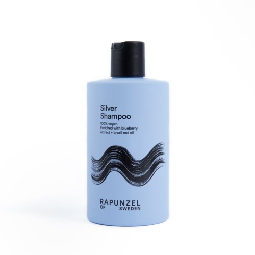 Blå flaska med svart lock, märkt "Silver Shampoo" med vågmönster, nämner blåbär och brasiliansk nötolja.