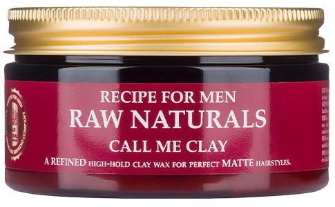 A small jar with a red label, gold lid, and white text. It says "Recipe for Men Raw Naturals Call Me Clay."