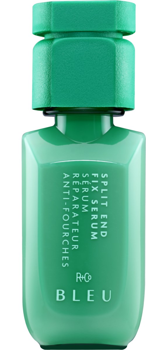 Een kleine groene fles met een bijpassende dop, gemarkeerd met witte tekst, waarschijnlijk een cosmetisch of huidverzorgingsproduct.