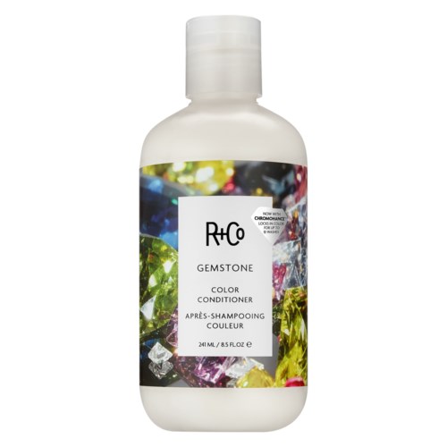 Witte fles R+Co gemstone kleurconditioner met kleurrijke edelstenen op het label.