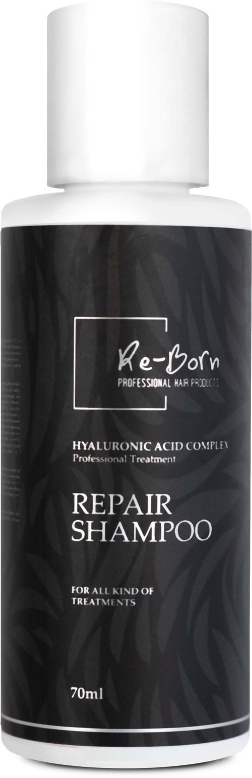 En svart och vit flaska märkt 'Re-Born Repair Shampoo' för alla behandlingar, innehåller 70 ml. Professionell hårvård.