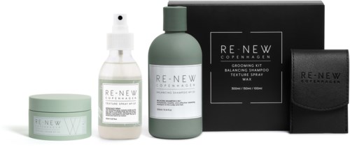 Et sæt af hårplejeprodukter med krukke, sprayflaske, shampoo og en sort pose, i et elegant design.