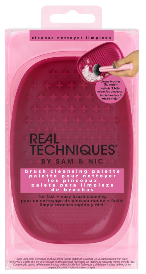 Pink cleaning palette with brushes inside, labeled 'Real Techniques' by Sam & Nic, for quick makeup brush cleaning.