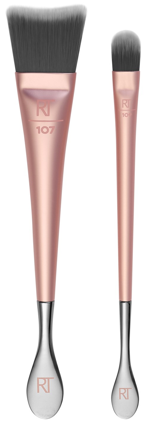 Två makeupborstar med rosa handtag och grå borst, en stor och en liten, används för makeup.