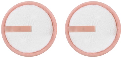 Två runda vita bomullsdynor med rosa kanter och små rektangulära stift i mitten.