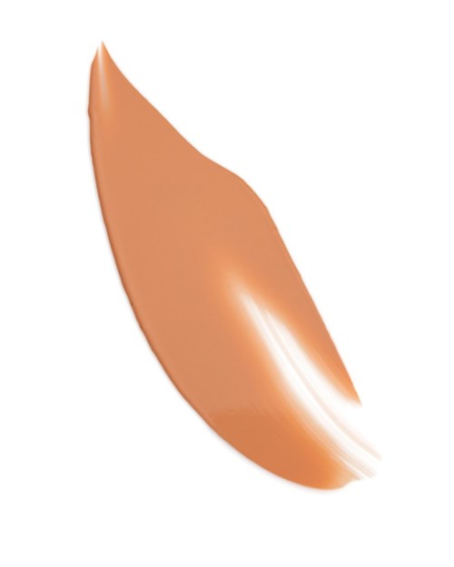 A beige, curved, smooth object with a shiny surface, resembling a small, polished pebble or a cosmetic item.