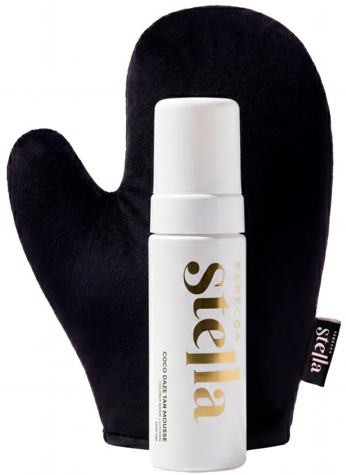 A white bottle with gold text next to a black oven mitt with a tag. The bottle reads Sugar and has a pump.