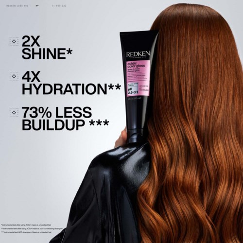 A woman with long, shiny red hair, holding a hair product bottle, with text highlighting hair benefits.