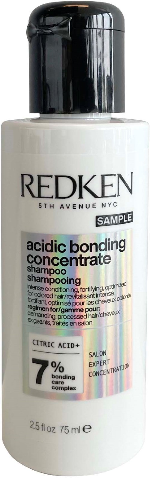 Valkoinen Redken-shampoon pullo, musta korkki, merkitty happopidätyskeskus, 75 ml.