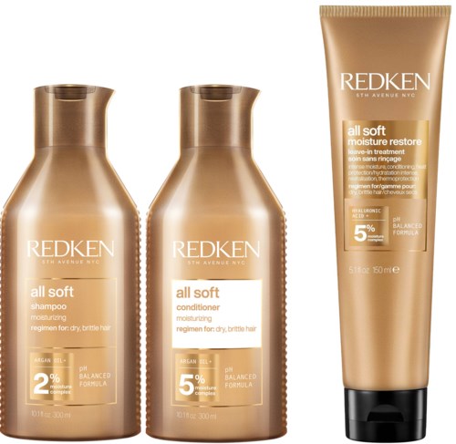 Kolme hiustenhoitopulloa Redkeniltä, sisältäen shampoon, hoitoaineen ja kosteuttavan hoitotuotteen, kaikki kultaisessa pakkauksessa.