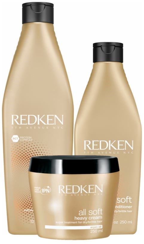 Three bottles and a jar of Redken hair products, including shampoo, conditioner, and heavy cream for hair.