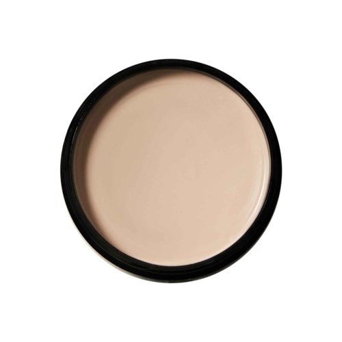 En rund behållare med beige substans, möjligen ansiktsgrund eller foundation, inuti. Behållaren har en svart kant.
