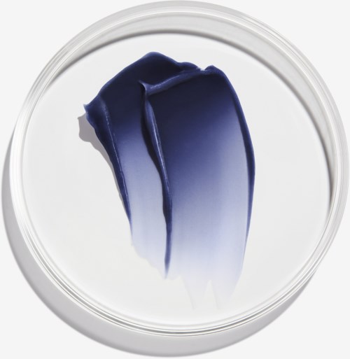 A dark blue gel or cream in a round clear container.