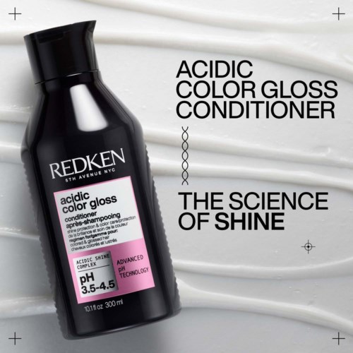 Redken Acidic Color Gloss Conditioner bottle on a white textured background. Focus on shine and hair care.