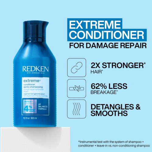 Blå flaska med Redken Extreme Conditioner för skadat och slingat hår. Den säger att håret blir starkare och mindre bräckligt.