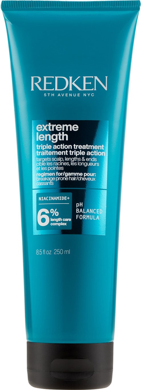 A blue tube of Redken hair treatment with black cap, labeled for extreme length and balanced formula. Contains 250 ml.