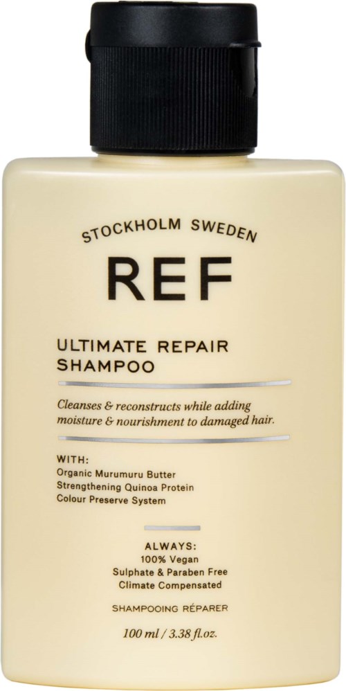 En beige flaske med REF-sjampo med svart lokk og etikett, inneholder hårreparasjon og næring.