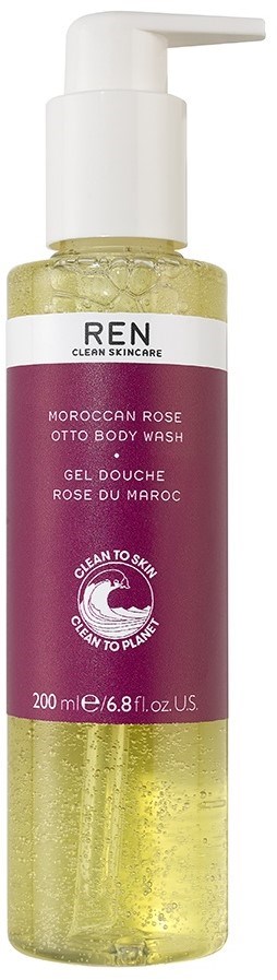 En klar plastflaska med vit pump, innehållande gult flytande, märkt 'Moroccan Rose Otto Body Wash'.