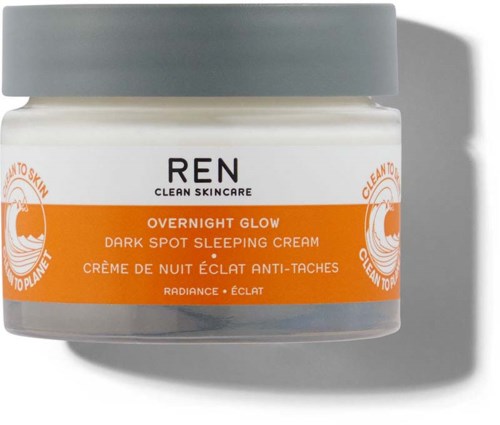 A small jar with a gray lid, orange and white label, and black text for overnight skin cream.