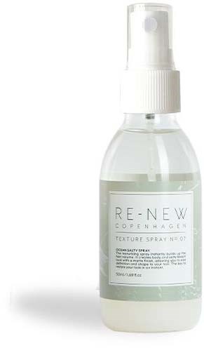 A clear spray bottle labeled 'RE-NEW Copenhagen' with a white spray cap, containing a liquid for skin or surface refreshment.