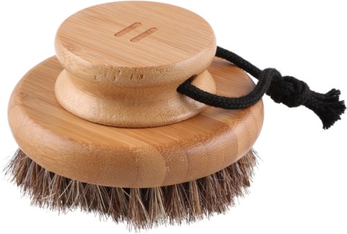 Circular wooden scrubber with a handle and a black string, used for cleaning. Contains bristles on the bottom side.