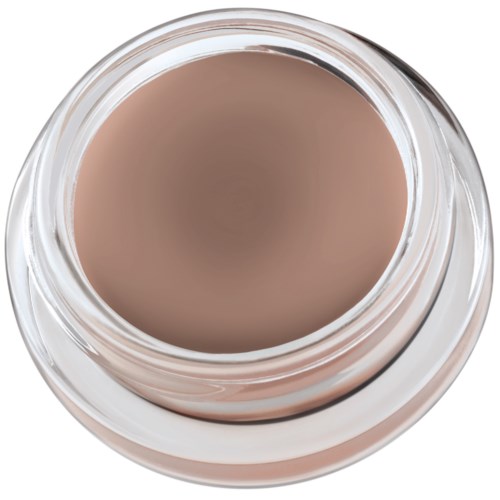Ett litet glasburk med beige kräm eller makeup inuti, sett uppifrån.