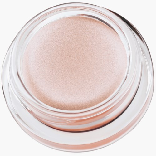 Ett burk med ljusrosa kräm eller makeup, sett ovanifrån. Burken är öppen och produkten är slät.