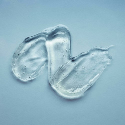 Two clear gel pieces with small bubbles on a blue background.