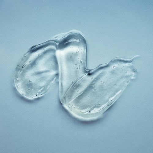 Two clear gel-like sheets with small bubbles, laid on a light blue surface.