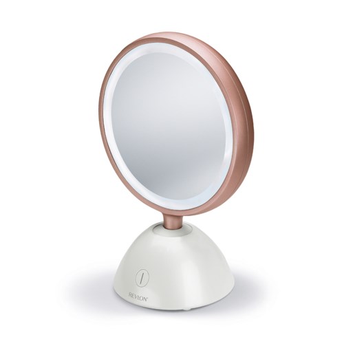 A round makeup mirror with a white base and a rose gold frame, standing on a flat surface.