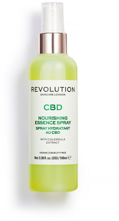 En grön och vit flaska med spraypump, märkt CBD Nourishing Essence Spray av Revolution Skincare.