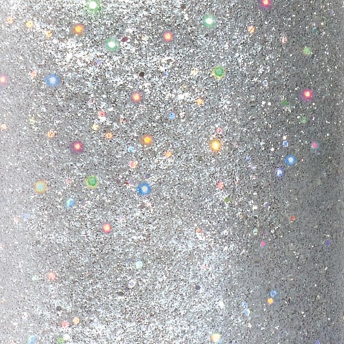 glittrande glitter på en grå bakgrund med små, färgglada prickar som är utspridda.