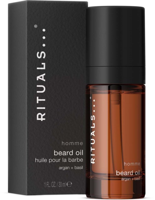 Een baardolie fles naast de zwarte doos, gemarkeerd 'RITUALS' en 'hombre beard oil, argan + basil.'