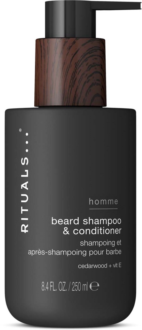 En svart flaska med ett trälock som innehåller skäggschampo och balsam, märkt Rituals Homme cedarwood och vitamin E.