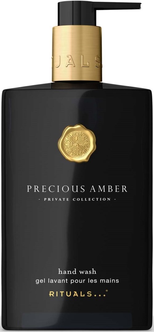Czarna butelka na ręcznik z charakterystyczną złotą pompą i etykietą z napisem Precious Amber, Private Collection i Rituals.