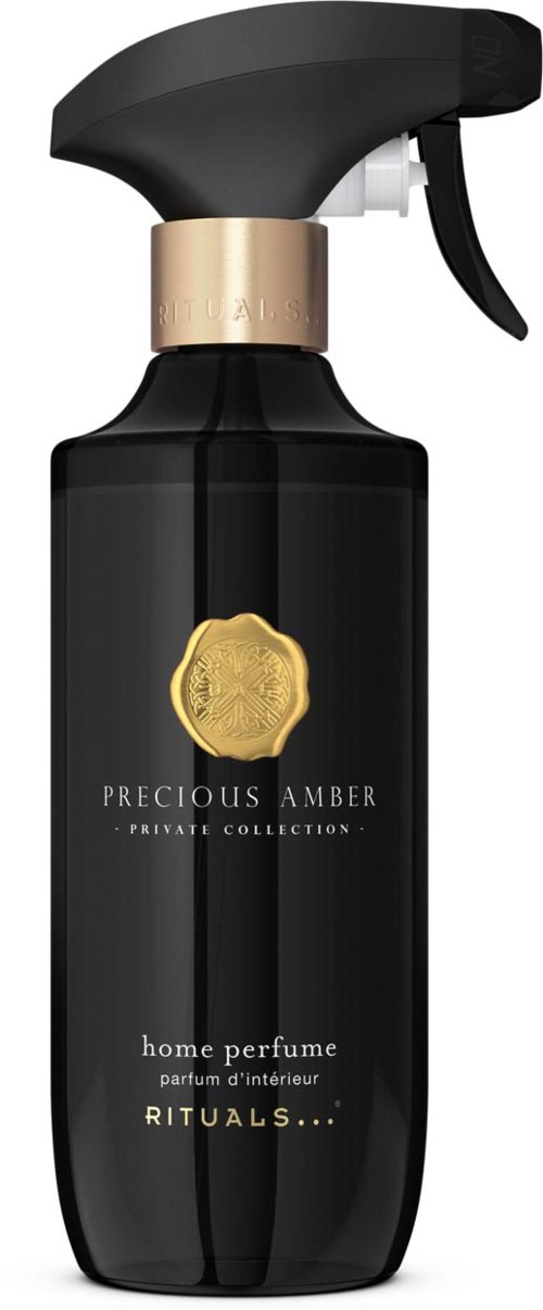 A black spray bottle with a gold seal, labeled Precious Amber home perfume from Rituals.