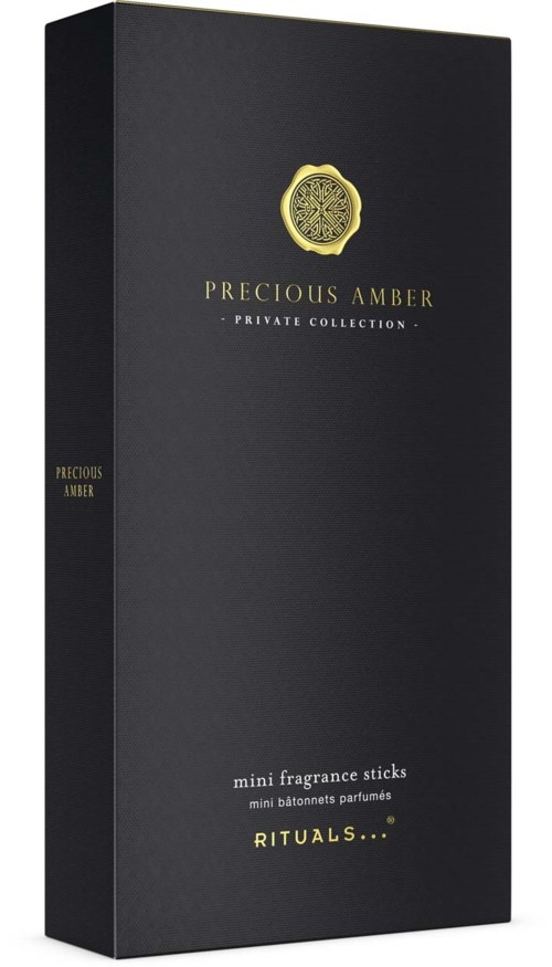 En lang, svart eske med gullfarget tekst og gullsymbol, merket "Precious Amber" og "Mini Fragrance Sticks."
