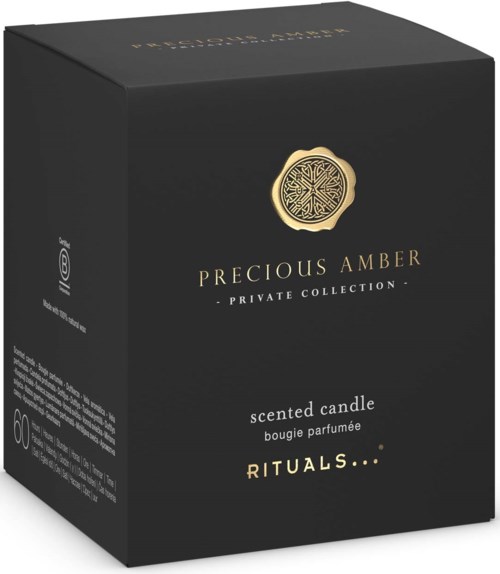Zwarte doos met gouden zegel en tekst voor een geurkaars uit de Precious Amber collectie.