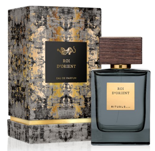 Een parfumfles met een bruine houtendop, gouden label en een getextureerde zwart-gouden doos.